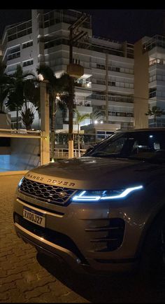 an suv is parked on the side of the road at night