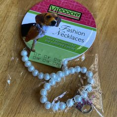 a bead necklace with a dog on it and a tag attached to the beads