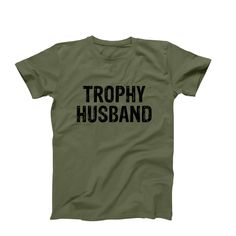 Trophy Husband T-Shirt, Funny Husband Shirt, Men's Funny Shirt, Trophy Spouse Shirt, Best Husband Anniversary Birthday Gift Idea ➤FEATURES: This listing includes one Unisex T-Shirt.  *  Available sizes S, M, L, XL, 2XL *  100%  Cotton *  Short Sleeve *  Crew Neck  ➤SIZING: Please keep in mind that our size chart measurements are NOT circumference.  UNISEX CREW NECK T-SHIRT SIZE CHART:  * S - 18" Width X 28" Length * M - 20" Width X 29" Length * L - 22" Width X 30" Length * XL - 24" Width X 31" L Anniversary T-shirt With Funny Text, Crew Neck, Funny Text Crew Neck T-shirt For Anniversary, Husband Tshirt, Trophy Husband, Funny Husband, Husband Anniversary, Husband Shirts, Husband Humor, Best Husband