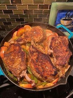 a pan filled with meat and vegetables on top of a stove