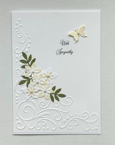 a white card with flowers and butterflies on it