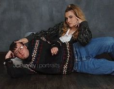 a man laying on the floor next to a woman