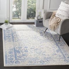 a white and blue rug in a living room