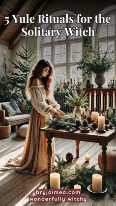 a woman standing in front of a table with candles