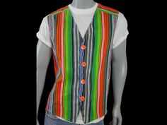 Size: 46 US/UK This multicolor vest has a stunning pattern of vertical stripes in green, orange, red, blue, silver, and white. The 1980s European cotton vintage waistcoat has a V neckline and closes in the front with four large round orange buttons. The pointed-front vest is lined in a blue cotton fabric. Chest = 46 inches (116.84cm) Vest Length = 26.5 inches (67.31cm) Material: Cotton Condition: Excellent (Professionally Cleaned ... soft and supple, with no stains, tears, wear spots, or weaknesses in the seams) Retro V-neck Fitted Vest, Casual Fitted Multicolor Vest, Fitted Multicolor Casual Vest, Multicolor Fitted Casual Vest, Fitted Multicolor Cotton Vest, Retro Multicolor Sleeveless Vest, Casual Multicolor V-neck Vest, Retro Multicolor Summer Vest, Multicolor Retro Summer Vest