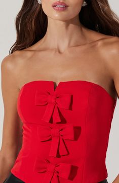 Turn on the charm in this sleek strapless crop top sweetened by a trio of darling bows. 13" center front length (size Medium) Side zip closure Strapless Lined 95% polyester, 5% elastane Dry clean Imported Red Gameday Outfit, Lovecore Clothes, Bow Top Outfit, Bow Tops Outfit, Bows Outfit, College Gameday Outfits, Gameday Outfits, College Gameday, Strapless Crop Top