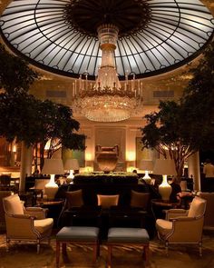 an elegant lobby with chandelier and seating