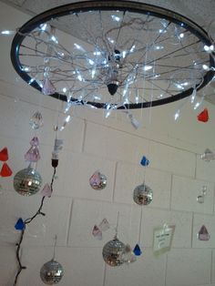 a chandelier with lights hanging from it's sides and decorations on the ceiling