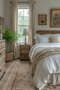 a bedroom with a bed, dressers and window in it's center area