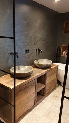 two bowls are sitting on the counter in this bathroom