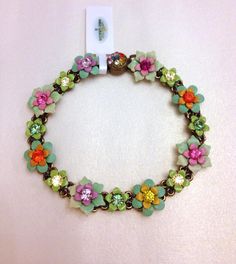 a bracelet with flowers and charms on it