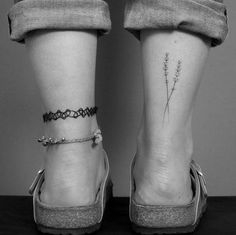 two people with tattoos on their legs and one is wearing high heeled shoes, the other