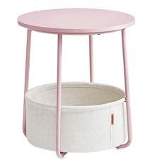 a pink and white table with a basket on it's side, against a white background