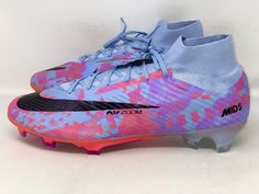 a pair of blue and pink soccer shoes