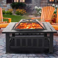 an outdoor fire pit with chairs around it