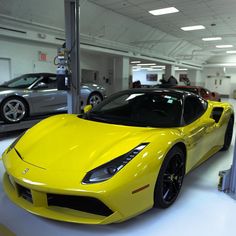 a yellow sports car parked in a garage