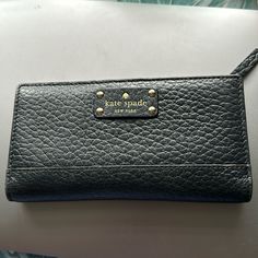 Questions? Leave A Comment Below! Kate Spade Black Bag With Card Slots, Kate Spade Leather Wallets For Everyday Use, Kate Spade Black Rectangular Wallet, Kate Spade Everyday Bifold Bag, Kate Spade Black Leather Wallet, Black Leather Kate Spade Wallets, Black Clutch Wallet For Daily Use, Black Bifold Clutch For Travel, Trendy Black Leather Wallet