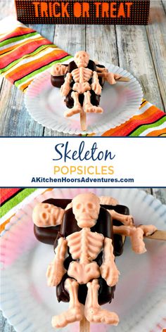 skeleton popsicles on a white plate with candy in the middle and an orange box behind them