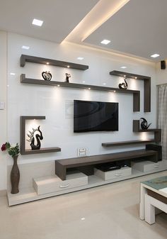 a modern living room with white walls and shelves