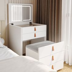 a white dresser with two drawers and a mirror on it's side next to a bed