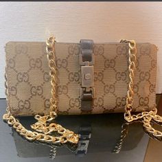 Reposhing This Vintage Gucci Gg Monogram Canvas And Leather Wallet In Brown. This Wallet Is Used, With Signs Of Wear Including Peeling, Fraying And Fading (See Pictures) But Still Has Lots Of Life Left! It Comes With A Removable Gold Chain (Unbranded) W/Hardware So It Can Be Worn As A Shoulder Bag Or Crossbody! The Wallet Has 7 Card Slots, Bill Compartment, Receipt Holder And Snap Coin Pocket. Most Cell Phones And Some Accessories Will Fit For Use As Crossbody. Please Reach Out With Any Questions- Happy Poshing! Gold Monogram Canvas Shoulder Bag With Branded Hardware, Designer Rectangular Wallets With Gold-tone Hardware, Designer Wallets With Gold-tone Hardware, Gucci Clutch Shoulder Bag With Gold-tone Hardware, Gold Monogram Canvas Crossbody Shoulder Bag, Designer Clutch With Chain Strap For Everyday Use, Designer Gold Clutch For Daily Use, Gucci Shoulder Bag With Chain Strap, Gucci Shoulder Bag With Chain Strap For Everyday Use