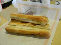 two hot dogs sitting on top of a table