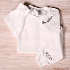 Personalized Mrs Embroidery Sweatshirt With Date On Sleeve, Custom Future Mrs Hoodie, Bridal Party Outfit, Engagement Gift, Bride To Be Gift Looking for a distinctive personalized sweatshirt? These embroidered sweatshirts offer a wonderful option for various occasions such as anniversaries, gifts for your significant other, or as a keepsake for a special milestone in your relationship. To Place Your Order: Begin by selecting your preferred sweatshirt color. Then, choose the size that fits you be White Hooded Top With Custom Embroidery, Fitted Long Sleeve Top With Custom Embroidery, White Long Sleeve Sweatshirt With Letter Embroidery, White Long Sleeve Hoodie With Embroidered Text, Mrs Hoodie, Outfit Engagement, Bridal Party Outfit, Future Mrs, Embroidery Sweatshirt