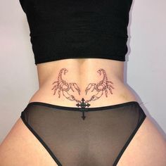 a woman's stomach with scorpion tattoos on her lower body and the bottom part of her panties