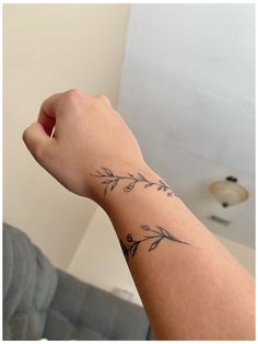 a person's arm with a tattoo on it, in front of a couch