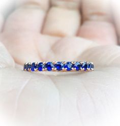 Full Eternity Band Ring with Natural Royal Blue Sapphires. MaterialSolid Gold (14K & 18K) or PLATINUM 950 FinishingHigh Polished/ Shiny PlatingOnly if WHITE GOLD - Rhodium/ Platinum Family FitComfort/ Rounded Width2.3 mm Height2 mm Setting TypePave StoneNatural Blue Sapphire QualityAAA Shape & CutRound, Diamond Cut Stone Size2 mm Quantity of Stones: apx 32 Click below to add laser engraving. https://www.etsy.com/listing/631070916/laser-engraving?ga_search_query=laser%2Bengraving&ref= Blue Round Eternity Band With Prong Setting, Formal Blue Sapphire Eternity Band, Blue Gemstone Eternity Band In Fine Jewelry Style, Elegant Blue Eternity Band With Vvs Clarity, Blue Diamond Cut Sapphire Ring, Blue Round Eternity Band For Anniversary, Blue Sapphire Eternity Band As Gift, Blue Sapphire Ring With Diamond Cut And Round Band, Blue Eternity Band For Formal Occasions