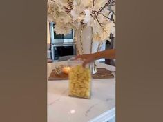 a vase filled with white flowers on top of a counter