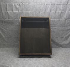 an empty wooden box sitting on top of a table