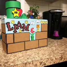 a cardboard box made to look like a super mario bros game on top of a counter