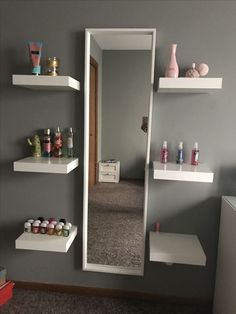 there is a mirror and shelves on the wall