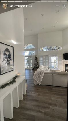 a living room filled with furniture and a flat screen tv sitting on top of a hard wood floor