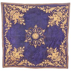 an old purple and gold cloth with floral designs