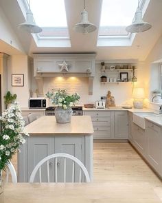 a kitchen filled with lots of counter top space next to a dining room table and chairs