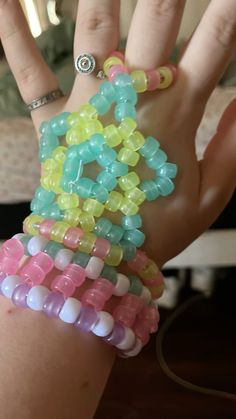 a woman's hand with several bracelets on it