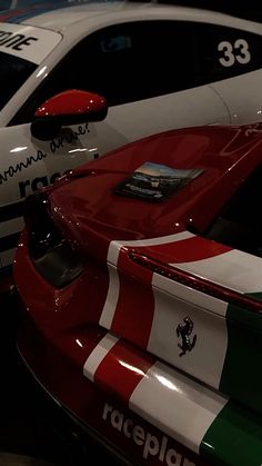 two race cars parked next to each other in a garage