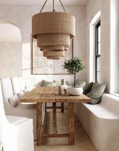 a living room with white couches and a wooden table