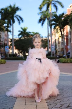 The Frances Couture Girls Ruffled Tulle Dress is a breathtaking choice for any young lady preparing to shine at her next pageant, special occasion, or as a flower girl. Its bodice is adorned with delicate tulle ruffles ensuring your little one stands out with elegance and grace. The dress features a voluminous floor-length skirt with multiple layers of tiered ruffles, supported by an inner petticoat that adds natural volume, making every twirl unforgettable. For a customizable look, the skirt of Ruffle Tulle Dress, Baby Christening Outfit, Girls Communion Dresses, Tulle Ruffles, Girls Crown, Flower Girl Crown, Girls Couture, Christening Outfit, Girls Pageant Dresses