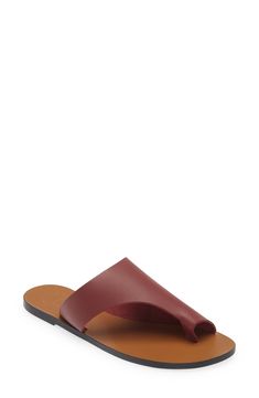 A cutout strap and sleek toe loop make this leather sandal a casual style standout. Leather upper, lining and sole Made in Italy Leather Toe Loop Slides For Spring, Modern Slides With Single Toe Strap And Leather Footbed, Modern Slides With Leather Footbed And Single Toe Strap, Chic Mules With Leather Lining And Single Toe Strap, Spring Leather Toe Loop Mules, Modern Flat Sandals With Leather Lining, Summer Leather Toe Loop Mules, Modern Leather Slides With Single Toe Strap, Leather Toe Loop Mules For Summer