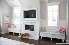 a living room filled with furniture and a flat screen tv on top of a fireplace