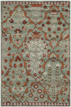 a blue rug with red and orange flowers on it, in the shape of an ornate design