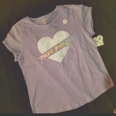 Pretty Lavender Tee Heart Includes "Pure Magic" In Pastel Glitter Letters 60%Cotton 40%Polyester Playful Purple Cotton T-shirt, Playful Purple Cotton Tops, Fun Short Sleeve Purple Tops, Fun Purple Short Sleeve Tops, Cute Purple Short Sleeve Shirt, Cute Purple Spring T-shirt, Fun Purple Cotton Tops, Playful Purple Short Sleeve Tops, Company Shirts