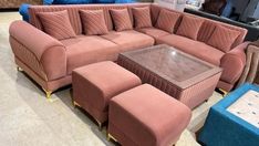 a living room with pink couches and footstools on display in a store