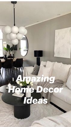 a living room filled with white furniture and lots of pillows on top of the couch