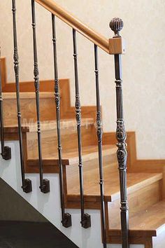 the stairs are made of wood and have metal balustiers on each handrail