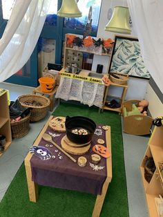 a room filled with lots of different items and decor on the floor in front of a window