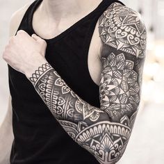 a man with tattoos on his arm and shoulder